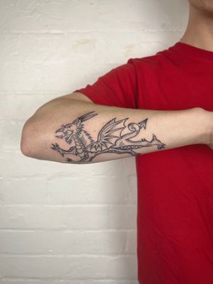 Elegant forearm tattoo featuring a fine line Japanese dragon tail design by Jack Henry Tattoo.