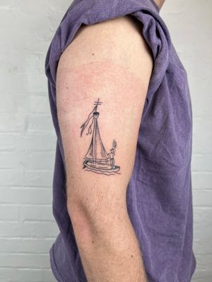 Captivating black and gray fine line tattoo of a man on a boat, expertly crafted by Jack Henry Tattoo on the upper arm.