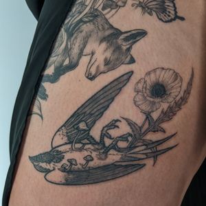 Get a stunning blackwork and illustrative tattoo featuring a swallow, flower, and mushroom, skillfully done by Alien Ink.