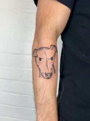 Unique forearm tattoo by Jack Henry featuring delicate dotwork and fine line details of a dog's ears.