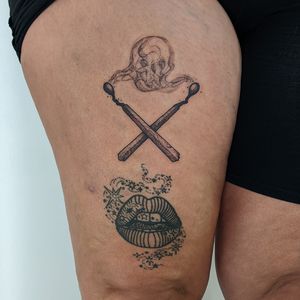 Get a unique blackwork tattoo of a skull engulfed in smoke with a burning match, hand-poked by the talented artist Alien Ink.