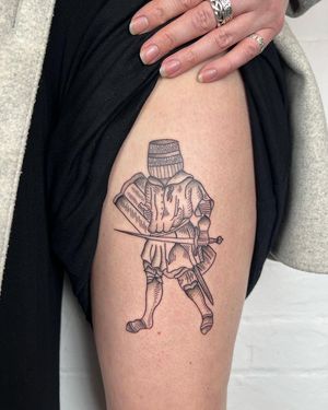 A finely detailed black and gray tattoo on the upper arm featuring a sword, knight, and barrel, by Jack Henry Tattoo.
