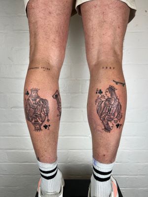 Black and gray fine line tattoo featuring small lettering of playing cards motifs by Jack Henry Tattoo on lower leg.