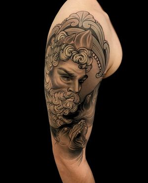 Capture the bond between man and his best friend with this black and gray neo traditional tattoo by Edyta, featuring intricate filigree details on the upper arm.