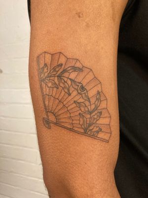 Elegant fine line design by Jack Howard featuring a beautiful combination of flowers and fans on the arm.