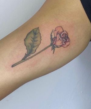 Elegant flower design by Rachel Angharad, perfect for the upper arm. Express your femininity with this stunning tattoo.