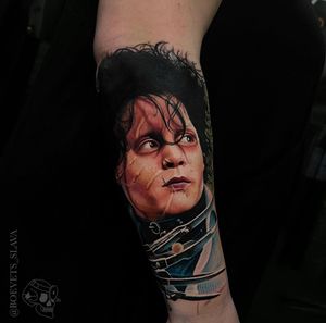 Realistic forearm tattoo featuring Johnny Depp as Edward Scissorhands, by Slava. A stunning tribute to the iconic character.