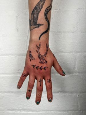 Unique hand tattoo featuring a delicate scorpion and majestic deer design by Jack Henry Tattoo.