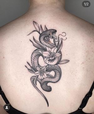 Embrace the allure of the serpent with this stunning black & gray fine line tattoo by the talented artist Laura May.