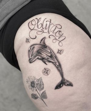 Experience the beauty of nature with this elegant black and gray dolphin tattoo designed by Laura May. Perfect for ocean lovers!