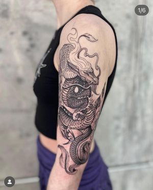 Experience the mystique with this stunning black and gray dragon tattoo, expertly crafted by the talented artist Laura May.