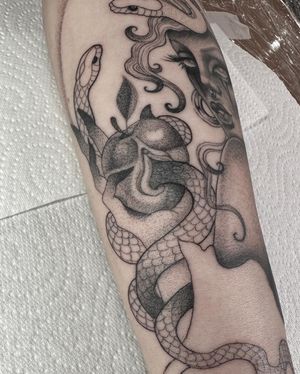 Experience the artistry of Laura May's black and gray snake tattoo, incredibly detailed and intricately designed. Perfect for those who appreciate fine line tattooing.
