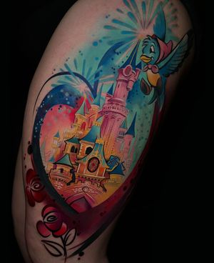 Vibrant new school tattoo on upper arm featuring a whimsical bird, Cinderella, and a castle, by Cloto.tattoos.