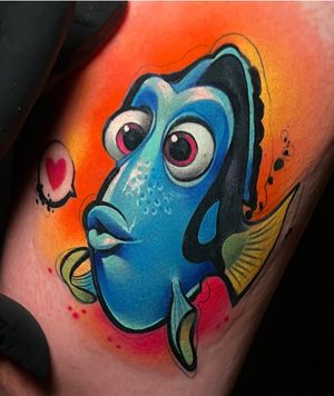 Vibrant watercolor new school tattoo of Dori, Nemo, and a fish on upper leg. By Cloto.tattoos.
