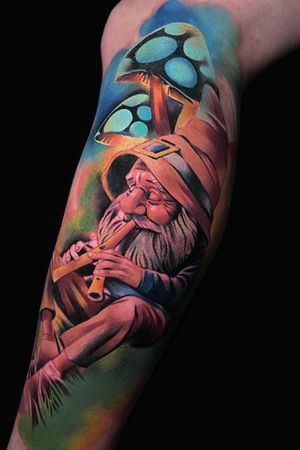Experience the whimsical world of dwarfs with a flute and mushroom in vibrant new school style by Cloto.tattoos on your lower leg.