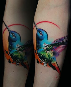 Vibrant watercolor hues fused with traditional tattoo elements, a stunning bird design by Cloto.tattoos.