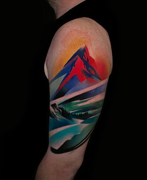 Neo-traditional style mountain tattoo on upper arm, featuring vibrant watercolor elements. Expertly done by Cloto.tattoos.