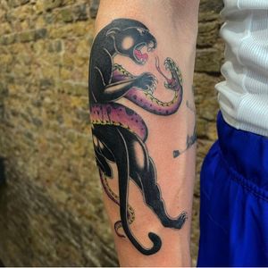 Classic forearm placement for this colour fine line traditional panther vs snake 