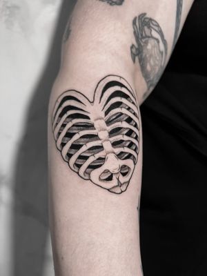 Unique blackwork and dotwork design by artist Andrew Garinther, combining a heart motif with ribcage anatomy.