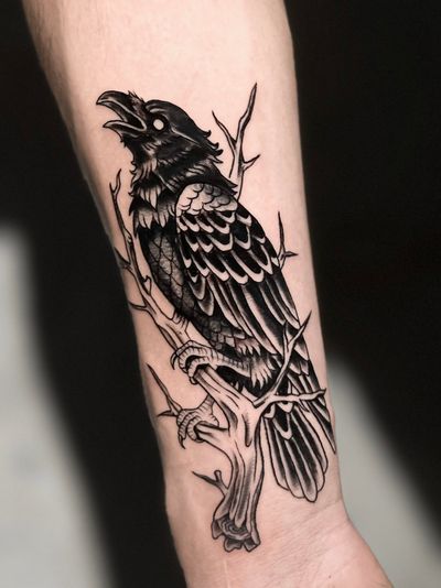 Check out this stunning blackwork tattoo featuring a detailed crow design created by the talented artist Andrew Garinther.