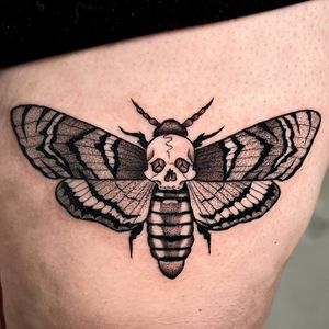 Unique blackwork moth tattoo by talented artist Andrew Garinther, featuring intricate dotwork and illustrative details.