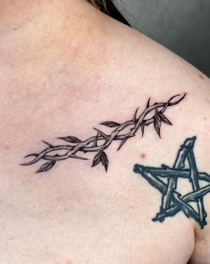Unique blackwork illustration by Andrew Garinther featuring a detailed branch with thorns design.