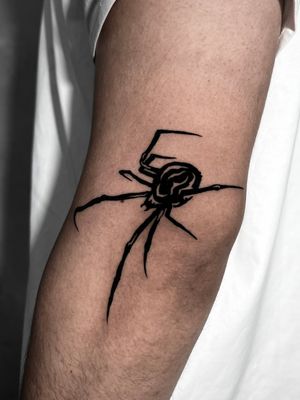 Get a stunning blackwork spider design by the talented artist Andrew Garinther. Perfect for those with a dark and edgy style.