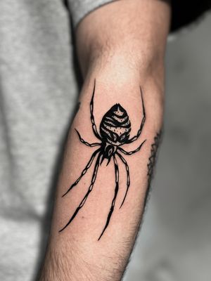 Discover the beauty of blackwork art with this intricately detailed spider tattoo by talented artist Andrew Garinther.