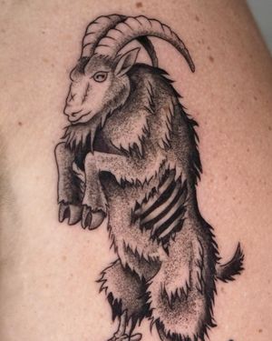 Experience the intricate beauty of blackwork and dotwork in this illustrative goat tattoo created by the talented artist Andrew Garinther.