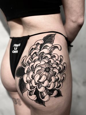 Elegant blackwork tattoo featuring a beautiful chrysanthemum flower, created by the talented artist Andrew Garinther.