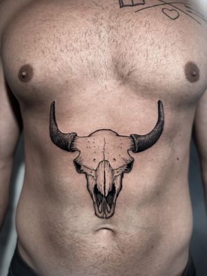 Illustrative tattoo of a cow skull designed by Andrew Garinther, featuring intricate blackwork style.