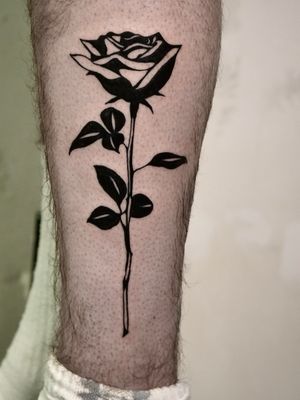 Get a stunning illustrative rose tattoo in bold blackwork style by the talented artist Andrew Garinther.