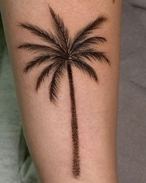 Get an intricate and stylish dotwork palm tree tattoo done by the talented artist Andrew Garinther. Perfect for nature lovers!