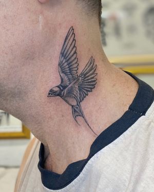 Stunning black and gray micro-realism bird tattoo on neck by artist Sophie Rose Hunter. Exquisite attention to detail.