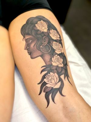 A stunning black and gray fine line tattoo of a girl with roses and a dangling earring on the upper leg, beautifully done by artist Sophie Rose Hunter.