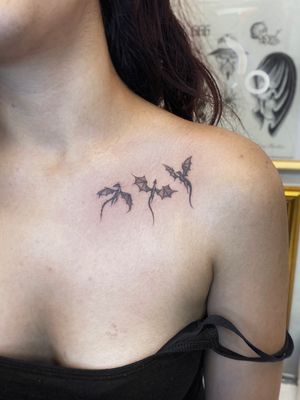 Experience the power and beauty of soaring dragons in this stunning black and gray chest tattoo by Sophie Rose Hunter.