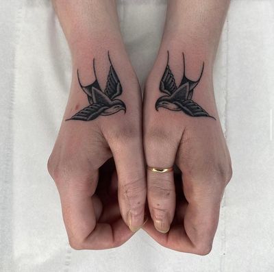 fine line pair of swallows on hands 