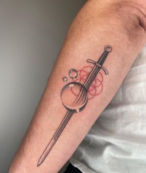 Hand poked sword and seed of life geometry design with water droplet distortion. Designed and executed by fmdtattoos. 