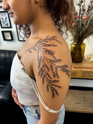 Check out this stunning plant tattoo on the chest by Jack Howard. The realism style really brings out the beauty of the botanical motif.