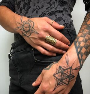 Pair of hand poked tattoos for the back of the hands. One curved and inspired by nature and florals, the other a hard and angular star tetrahedron. Designed and executed by fmdtattoos.