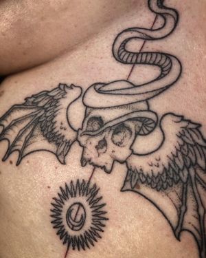 Winged skull with snake and combined sun/moon design on the sternum. Designed and a executed by fmdtattoos. 