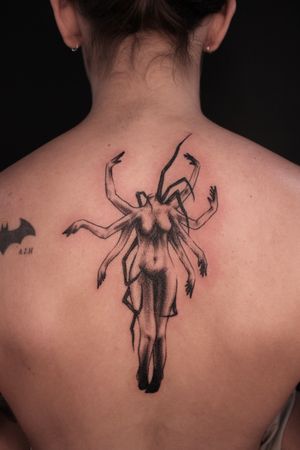Captivating black and gray upper back tattoo by José featuring a female figure with spider arms in a surrealistic style.
