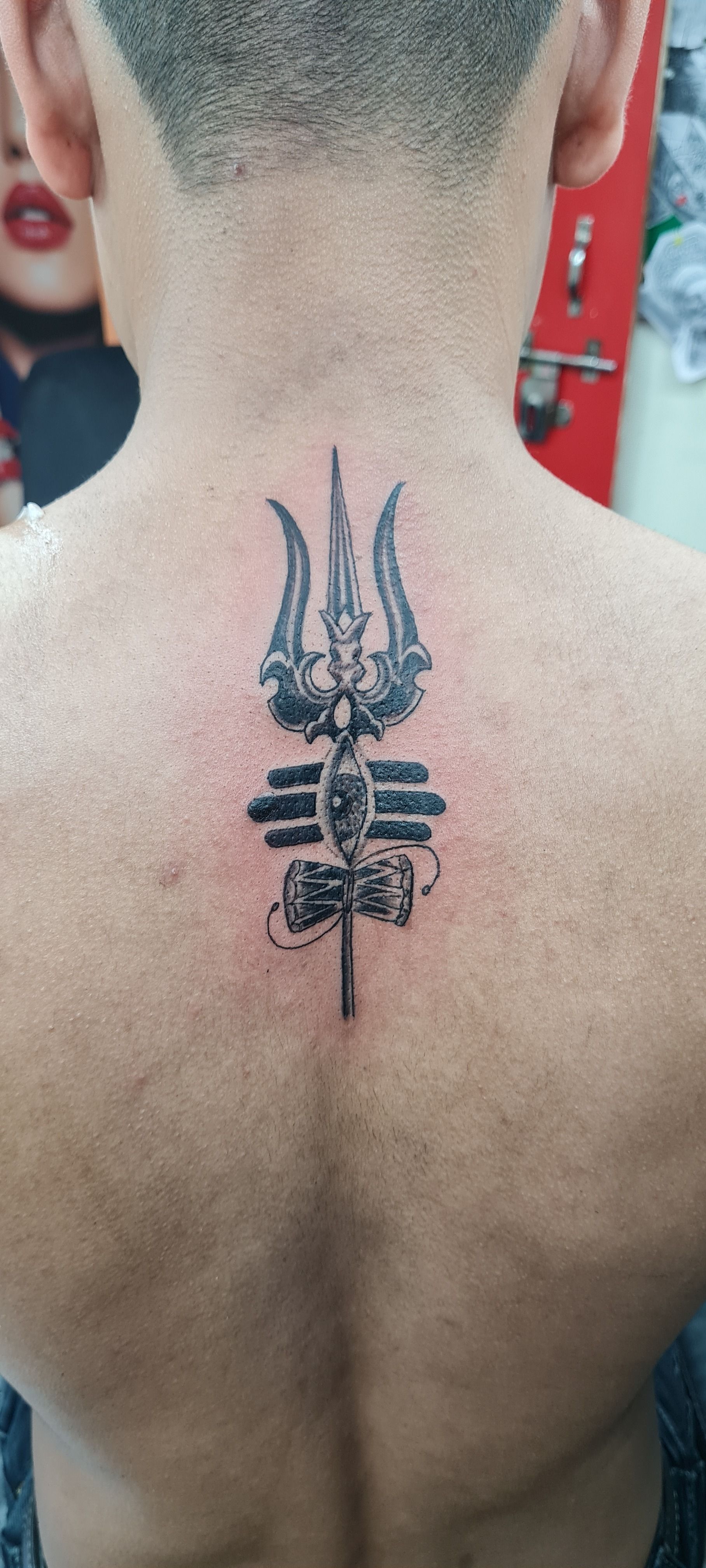 Amazing black ink trishul tattoo on back neck | Trishul tattoo designs,  Neck tattoo for guys, Tattoos for guys