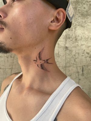 Elegant micro realism swallow tattoo on neck by renowned artist Rich Sinner. Minimalist and detailed design.