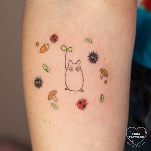 Get a cute and kawaii Studio Ghibli inspired tattoo by Mika Tattoos. This fine line design features a chibi Totoro in vibrant colors.
