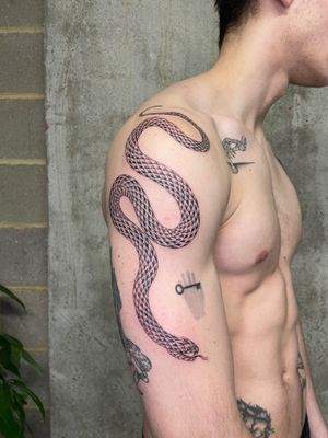 Get a bold and classic snake tattoo done by the talented artist Rich Sinner.
