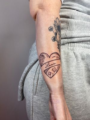 Exquisite dotwork and fine line design by Joanna Webb on your lower arm. Show off your love for flowers and hearts with this beautiful tattoo.