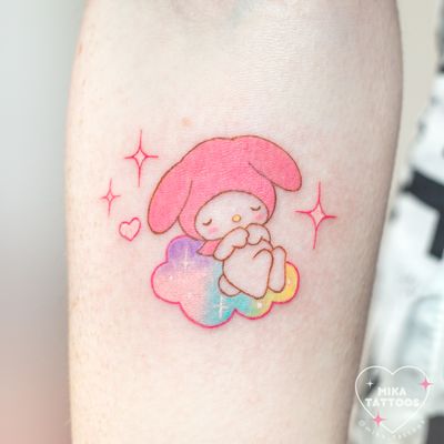 Adorable watercolor tattoo by Mika Tattoos featuring My Melody in a kawaii style with fluffy clouds.