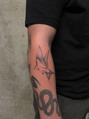 Fly high with this stunning illustrative swallow tattoo by the talented artist Rich Sinner. Embrace freedom and grace with this timeless design.