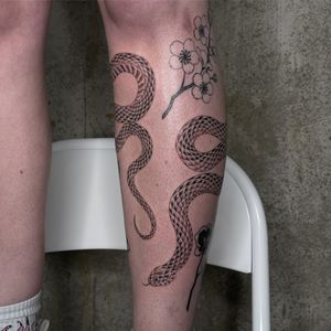Get inked with a classic illustrative snake design by the talented artist Rich Sinner. Embrace the timeless tradition of tattooing with this captivating piece.